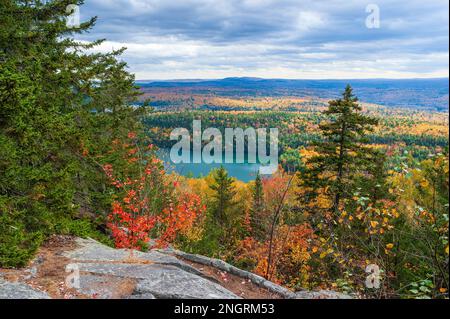 Maine Highlands landscape. Little Greenwood Pond - a mountain lake with emerald waters. Mixed forest in peak fall foliage. Borestone Mountain, Maine. Stock Photo