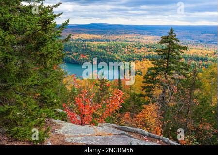 Maine Highlands landscape. Little Greenwood Pond - a mountain lake with emerald waters. Mixed forest in peak fall foliage. Borestone Mountain, Maine. Stock Photo