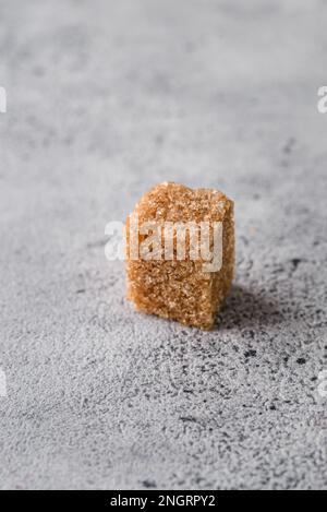 brown sugar cubes on a gray background. Macro Stock Photo