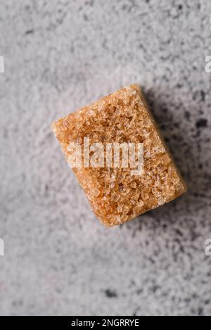 brown sugar cubes on a gray background. Macro Stock Photo