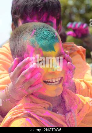 India, Madhya Pradesh, Jabalpur : Ved Pathi students smearing 'gulal' powder on each other's faces as they celebrate Holi festival at Narmada Ved Vigyan sanskrit Vidyalaya in Jabalpur. Photo by - Uma Shankar Mishra Stock Photo