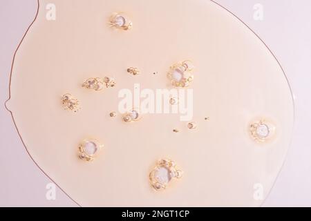 Cream gel pink transparent cosmetic sample texture with bubbles isolated on pink background Stock Photo