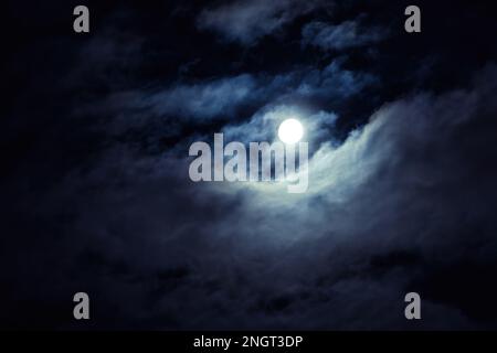 Night sky with full moon for background, concept of horror, Halloween, mystery. Dramatic spooky clouds in moonlight from full moon. Dark gothic sky wa Stock Photo