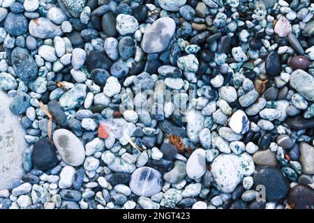 ground texture of rounded pebbles nearby the sea Stock Photo
