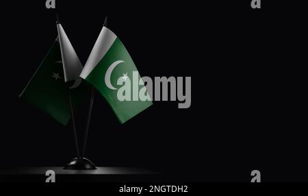 Small national flags of the Pakistan on a black background. Stock Photo