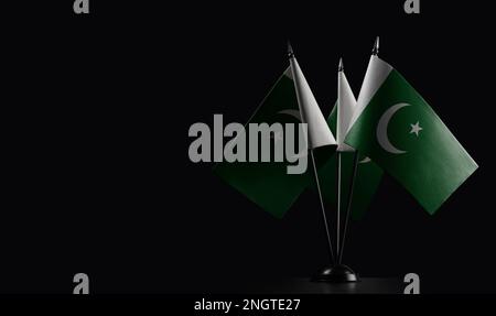 Small national flags of the Pakistan on a black background. Stock Photo