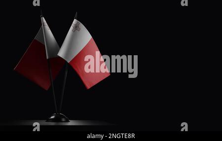 Small national flags of the Malta on a black background. Stock Photo