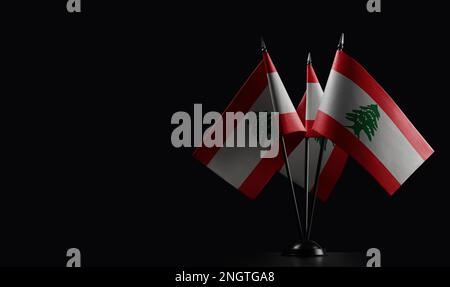 Small national flags of the Lebanon on a black background. Stock Photo