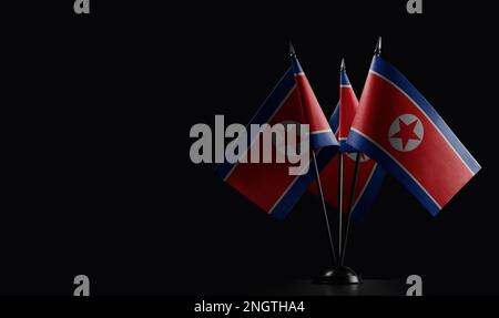 Small national flags of the North Korea on a black background. Stock Photo