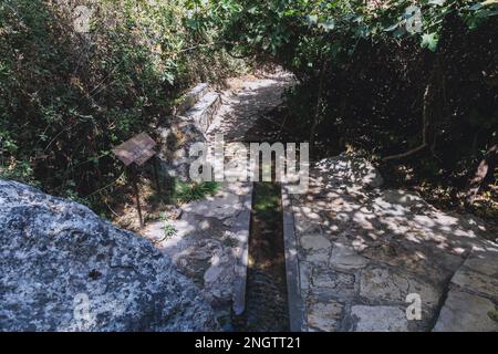 Path to Natural grotto of the Baths of Aphrodite Botanical Garden in Akamas National Forest on the Akamas Peninsula, Paphos District in Cyprus Stock Photo