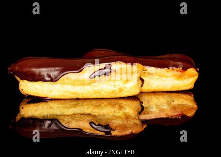 Two chocolate eclairs, macro, isolated on black background. Stock Photo