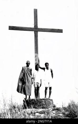 People standing next to the large cross at the top of Mount Gemi near Amedzofe in Volta Region, Ghana c.1958 Stock Photo