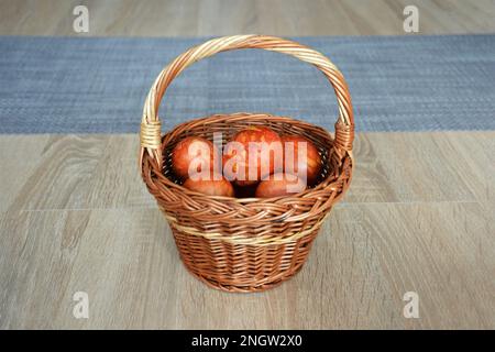Easter eggs in the basket. Easter egg dyed with onion peel. Happy Easter concept. Stock Photo