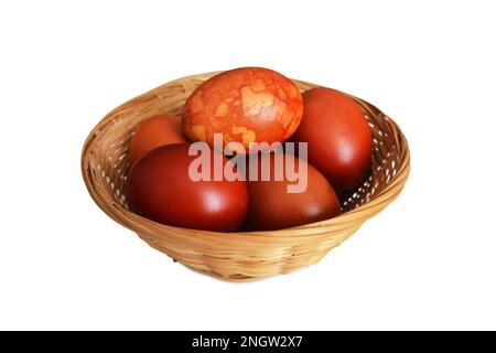Easter basket with naturally dyed Easter eggs isolated on white background Stock Photo