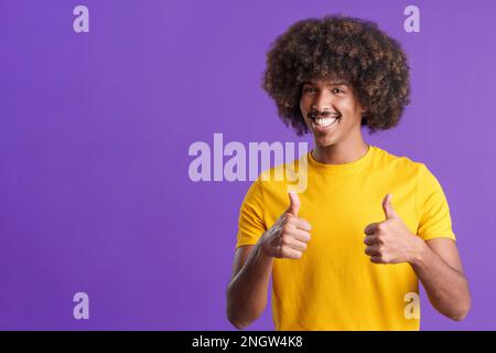 African man with curly hair gesturing agreement raising thumbs up Stock Photo