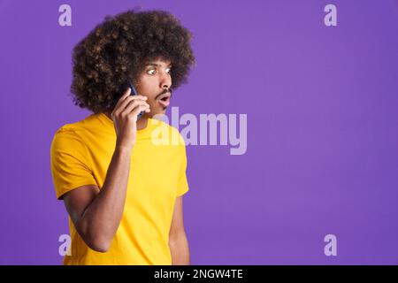 Surprised african man talking to the mobile Stock Photo