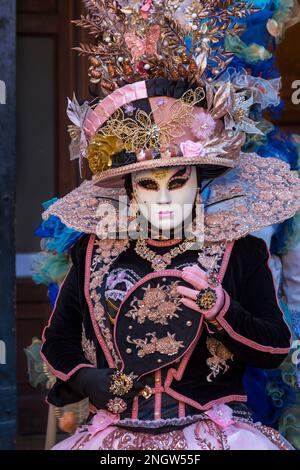Carnival goer dressed in splendid costume and mask during Venice Carnival 2023 at San Polo, Venice, Italy in February Stock Photo