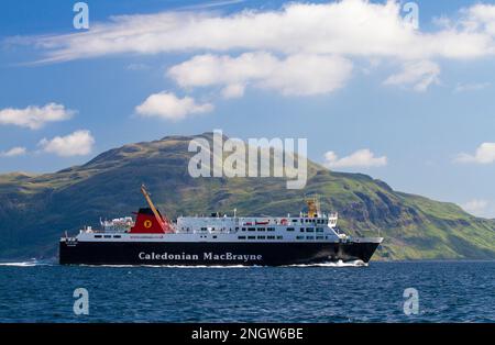 The Caledonian MacBrayne ferry ,MV Isle of Lewis passenger ferry makes it way to Oban along the Sound of Mull, passing Ben Hiant in Ardnamurchan. Stock Photo