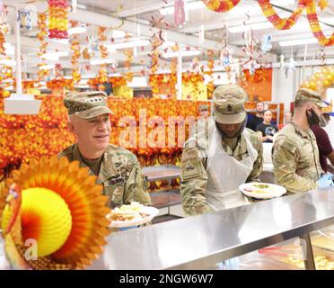 Service members and civilians at Camp Arifjan, Kuwait, enjoy a ...