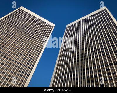 Modernist office tower buildings mirror one another Stock Photo