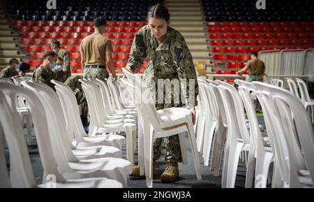 SANTO DOMINGO, Dominican Republic (Nov. 28, 2022) Hospitalman Bailey Leitgeb, assigned to the hospital ship USNS Comfort (T-AH 20), sets up chairs at the medical site during Continuing Promise. Continuing Promise 2022 is a humanitarian assistance and goodwill mission conducting direct medical care, expeditionary veterinary care, and subject matter expert exchanges with five partner nations in the Caribbean, Central and South America. Stock Photo