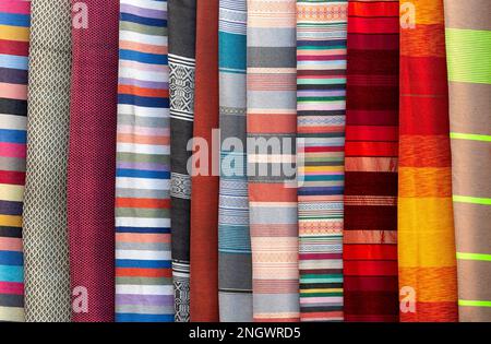 stacked colorful fabrics in the Grand Bazaar in marrakesc, Marocco Stock Photo