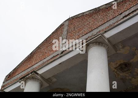 Capital at the top of the column. A beautiful architectural element. The top of the column. Old abandoned cracked column capital with peel of the pain Stock Photo