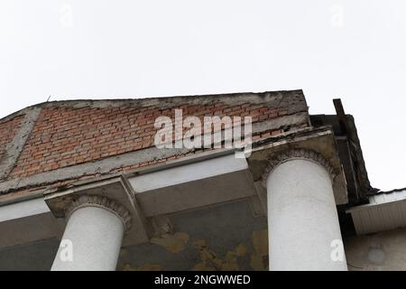 Capital at the top of the column. A beautiful architectural element. The top of the column. Old abandoned cracked column capital with peel of the pain Stock Photo