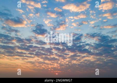 Cirrus clouds on the sunset sky. Nature background Stock Photo