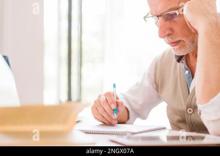 senior professor glasses writing notebook classroom Stock Photo