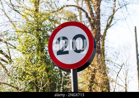 UK Traffic sign showing.a 20 mph maximum speed limit with a red and white warning circle Stock Photo