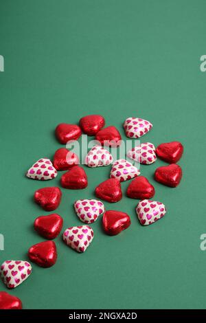 photo many hearts lying on a green background Stock Photo