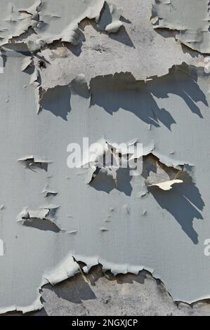 Old blue peeling paint on a wall, textured background Stock Photo