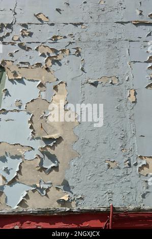 Old blue peeling paint on a wall, textured background Stock Photo