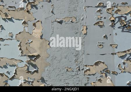 Old blue peeling paint on a wall, textured background Stock Photo