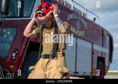 U.S. Air Force Staff Sgt. Hunter Larsen, 6th Civil Engineer Squadron firefighter, dons a helmet during a shadow day event at MacDill Air Force Base, Florida, Nov. 30, 2022. The 6th CES firefighters showcased their career field to Airmen from the 6th Logistics Readiness Squadron. Stock Photo