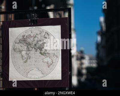 Old vintage world map of Europe, Africa and Asia hung at a street vendor in aa city Stock Photo