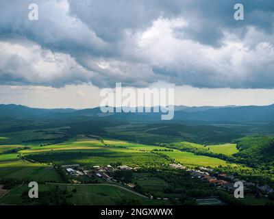 Aerial view of rural eastern european landscape with hills village and cloudy sky sunlight agricultural fields Fuzer, (Füzér) Hungary Stock Photo