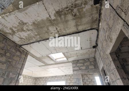 Construction of an individual residential building, view of the monolithic reinforced concrete ceiling in the house with an opening for stairs to the Stock Photo