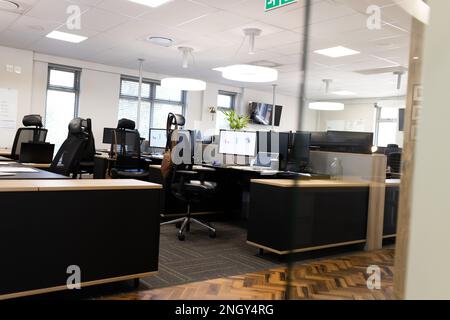 Empty open space office with desks, chairs and computers Stock Photo