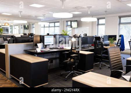 Empty open space office with desks, chairs and computers Stock Photo