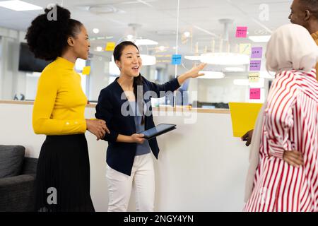 Diverse businesswomen talking and brainstorming in office Stock Photo