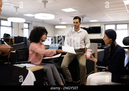 Group of diverse people in office working with documents Stock Photo