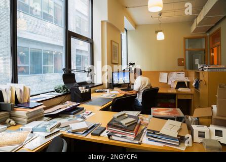 The architect Andre Ibghy of the firm Andre Ibghy Architects Inc at his work desk in his downtown Montreal office in old 1910 residential building. Stock Photo