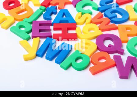 Many colorful magnetic letters on white background Stock Photo