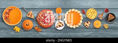 Flat lay composition with different tasty pies on wooden table. Banner design Stock Photo