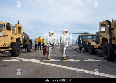 PACIFIC OCEAN (Dec. 2, 2022) – Members of the crash and salvage crew aboard dock landing ship USS Harpers Ferry (LSD 49) stand by for flight operations on the ship’s flight deck during exercise Steel Knight 23 (SK23), Dec. 2, 2022. SK23 provides U.S. 3rd Fleet and I Marine Expeditionary Force with an opportunity to practice amphibious operations and demonstrate that amphibious forces can access critical areas that shape actions across the range of military operations to resolve conflict, conduct humanitarian assistance or combat the adversary. Steel Knight is an annual combined-arms live-fire
