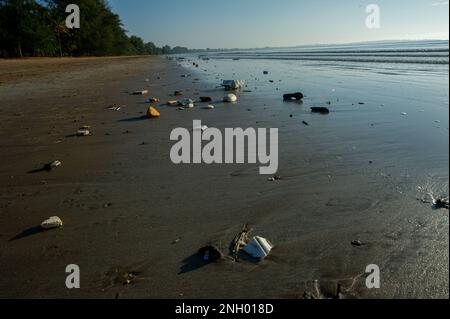 Plastic waste on the beach in Thailand carried by the tide and remaining on the beach Stock Photo