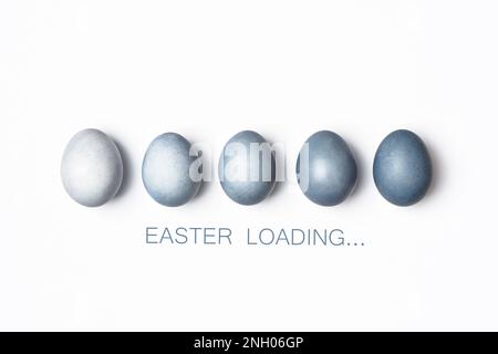 Dyed blue gradient Easter eggs row on white. Easter loading concept. Creative greeting card, minimal. Stock Photo