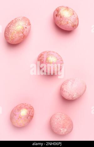 Pink Easter eggs, pastel Easter background. Monochrome greeting card, flat lay. Stock Photo